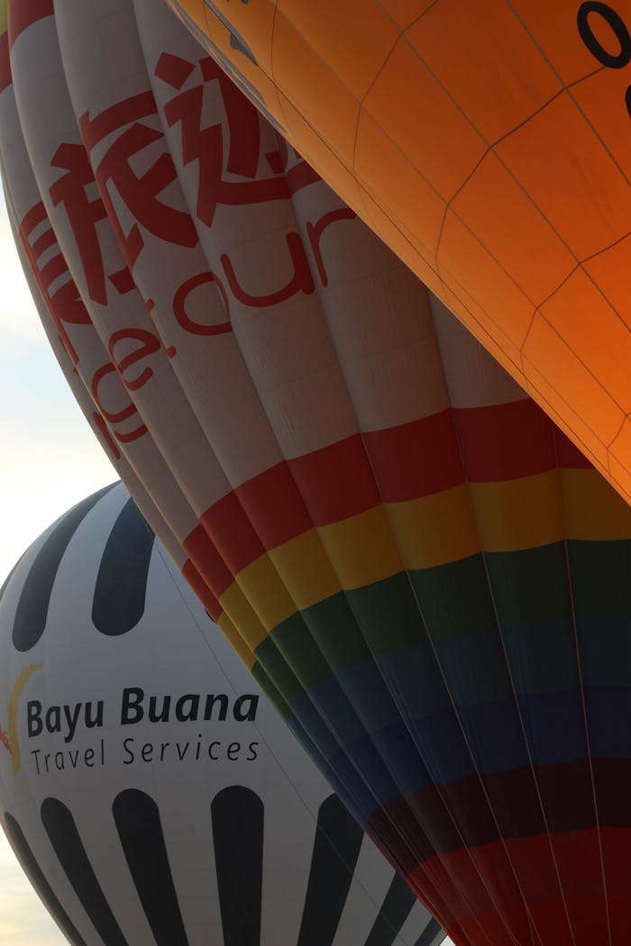 Close-up of colorful hot air balloons filling the sky at sunrise.